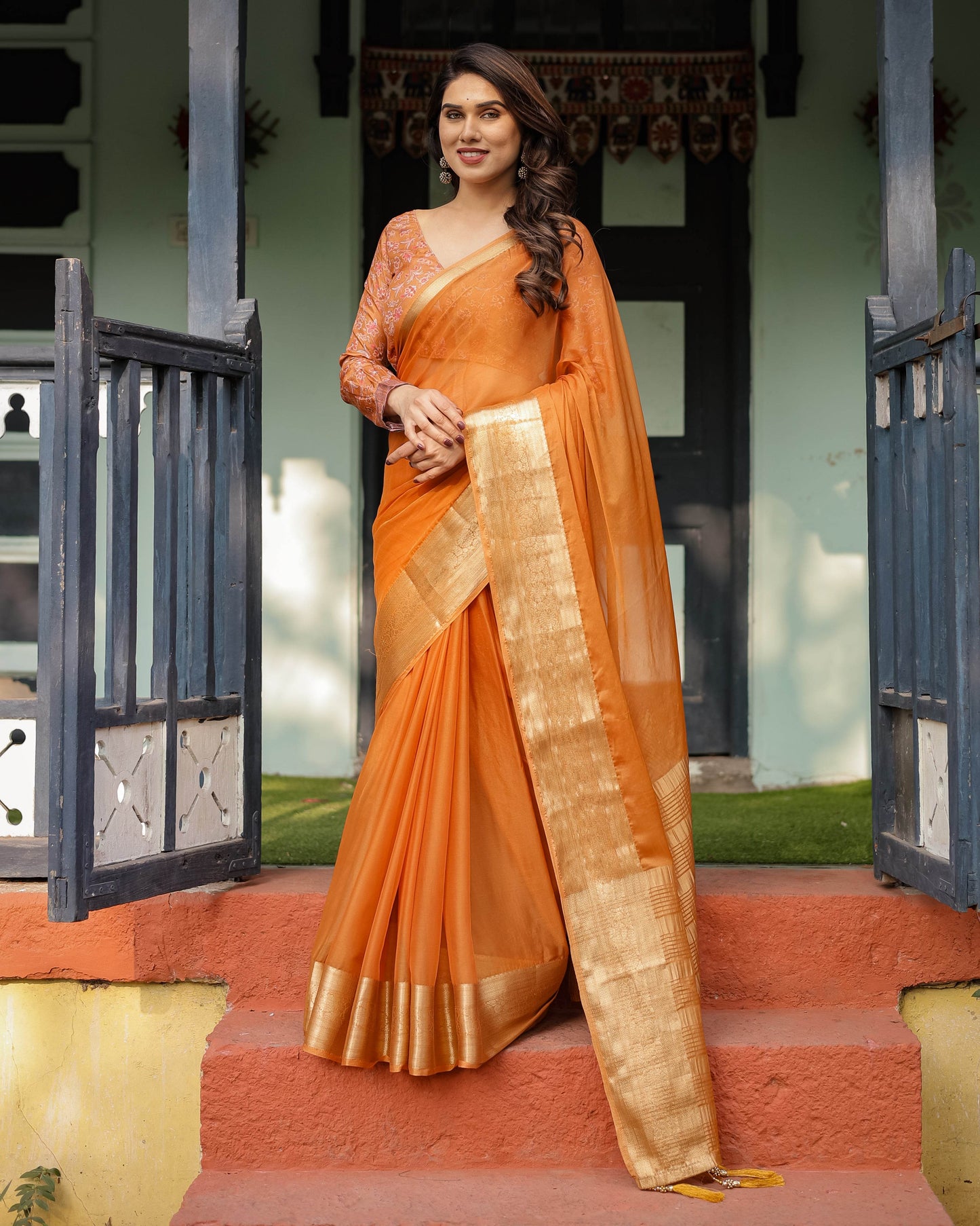 Sunset Orange Plain Chiffon Saree with Gold Zari Border, Floral Embroidered Blouse & Tassel Detailing - SEEANS